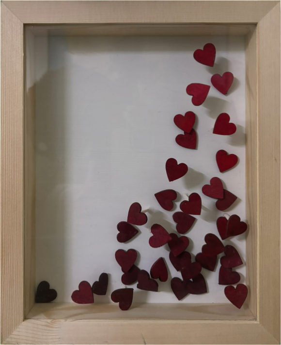 Falling (I) — cascade of red-maroon wooden hearts in natural-wood shadow-box frame