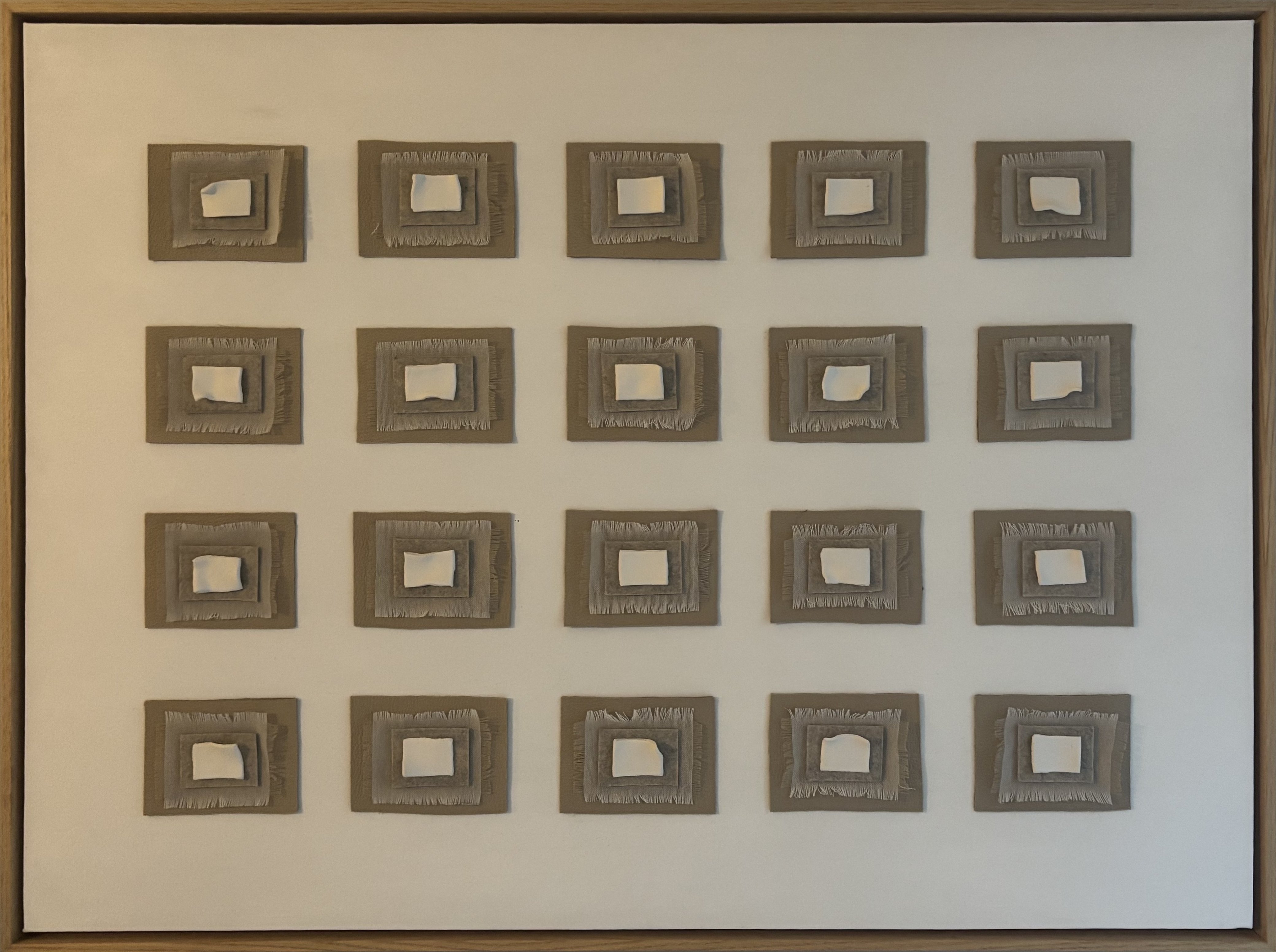Remnants — five by four grid of assemblage cells on textured white ground